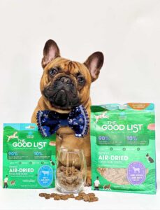 imge of dog with the good list in beef and lamb, venison & bone broth with a bowl of treats in front of him